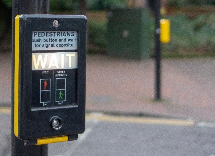 A British pedestrian crossing with the word WAIT illuminated