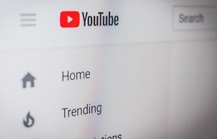 An image of the YouTube menu. The YouTube logo is seen next to a 'Search' bar. Below it are the menu options 'Home' and 'Trending'
