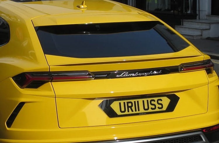 Photograph of the rear of a yellow Lambourghini and its number plate