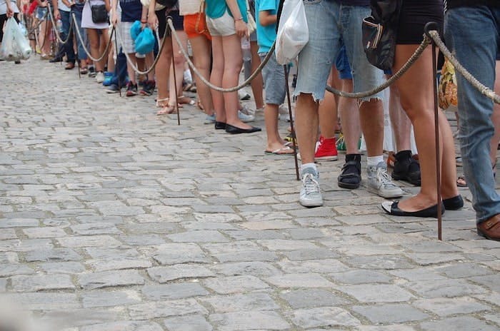 Photograph of people waiting in a queue