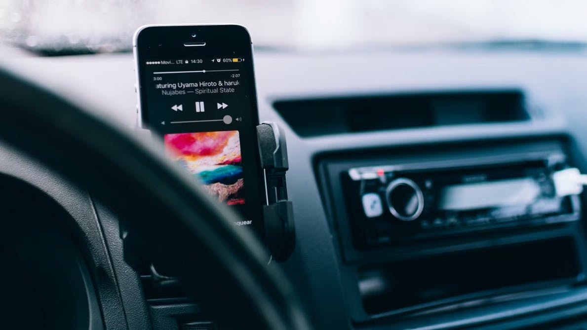 An iPhone playing music in a car to help the driver deal with road rage