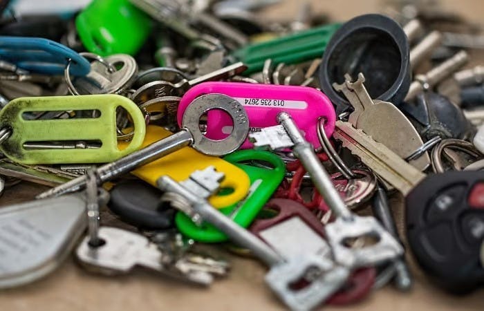 Assorted car keys and locks on table