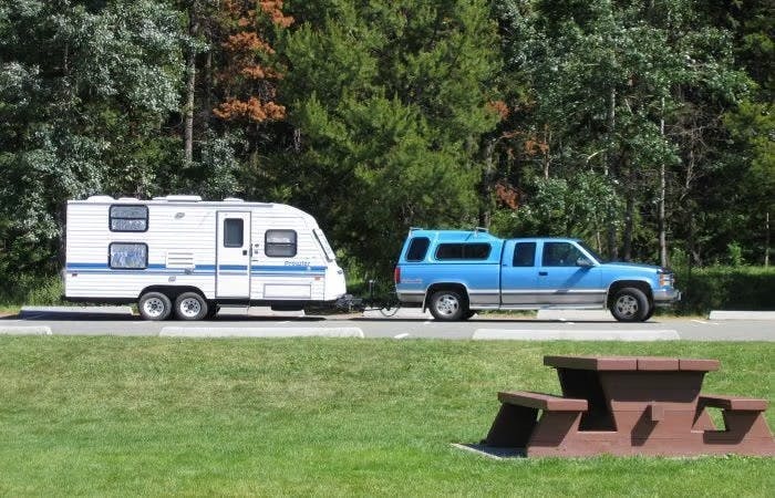 Blue truck towing trailer
