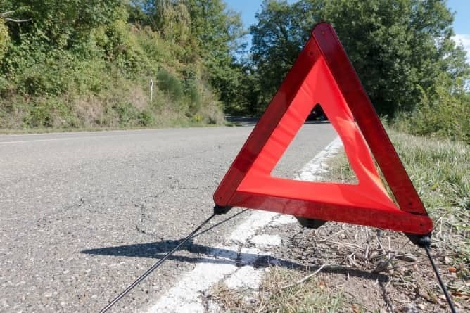 Photograph of a warning triangle placed on a country road