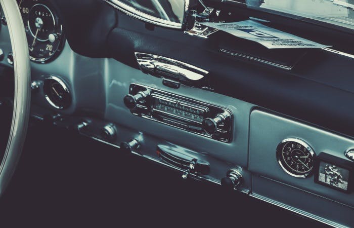 An image of a vintage car and its stereo