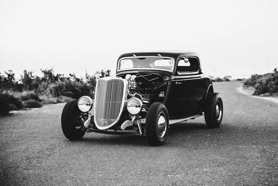 A black and white image of a 1933 ford car