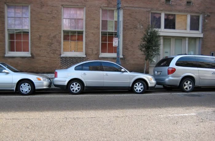 Photograph of three cars parallel parked
