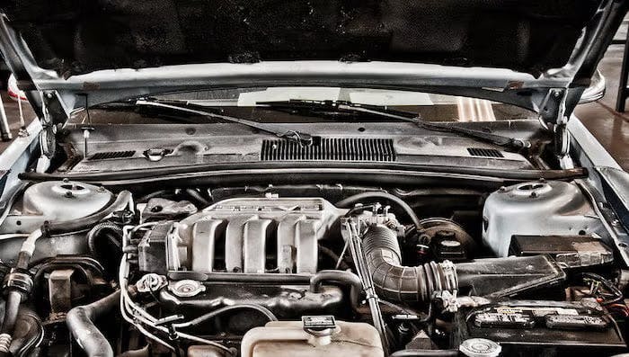An image of a car engine under an open car hood 