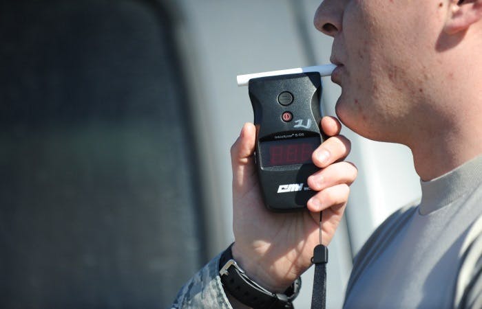 An image of a person taking a breathalyser test 