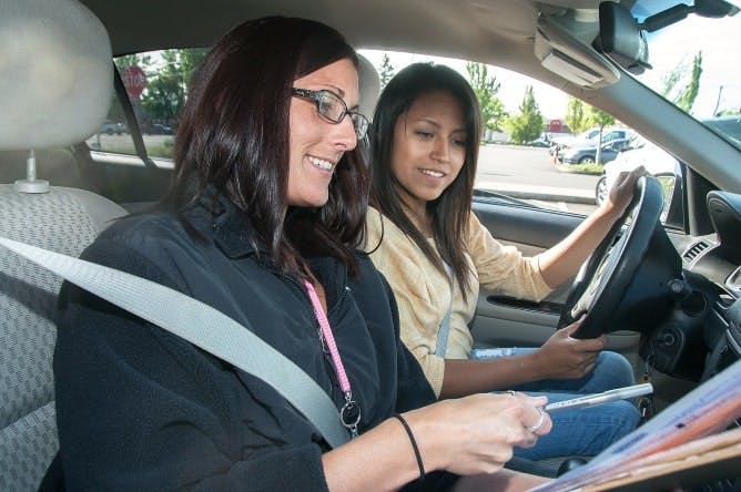 a driving instructor talks a learner driver through a manouevre