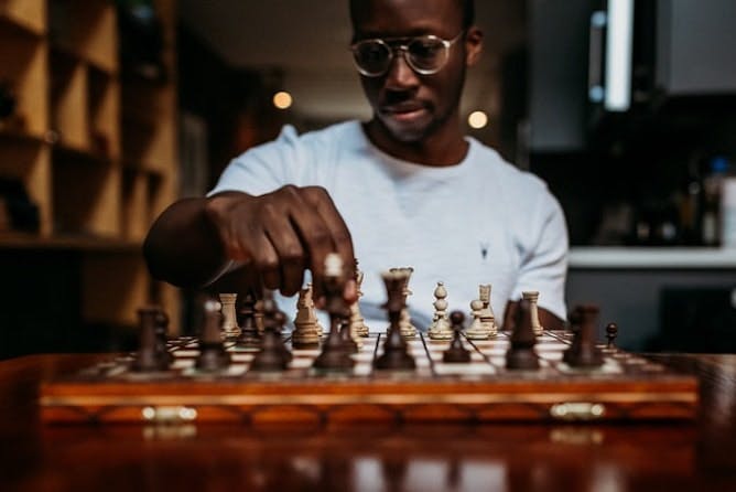 Man with glasses playing chess