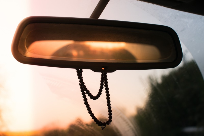 Interior car mirror with a string of beads attached
