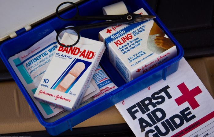 First aid kit containing bandages plasters and scissors