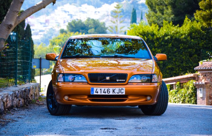 front-shot-of-orange-car-in-sun
