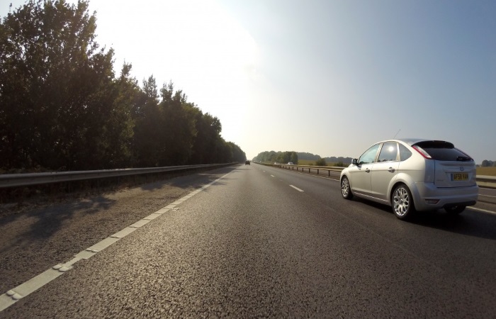 silver-car-driving-on-right-hand-lane-of-motorway