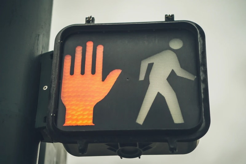 Red stop hand light at a pedestrian crossing