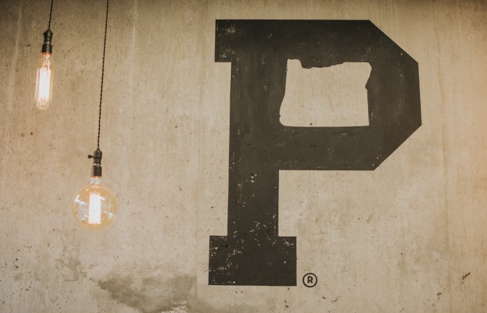 two-bulbs-handing-from-ceiling-next-to-painted-letter-p