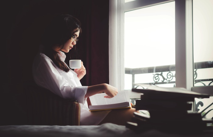 woman-sat-by-window-reading