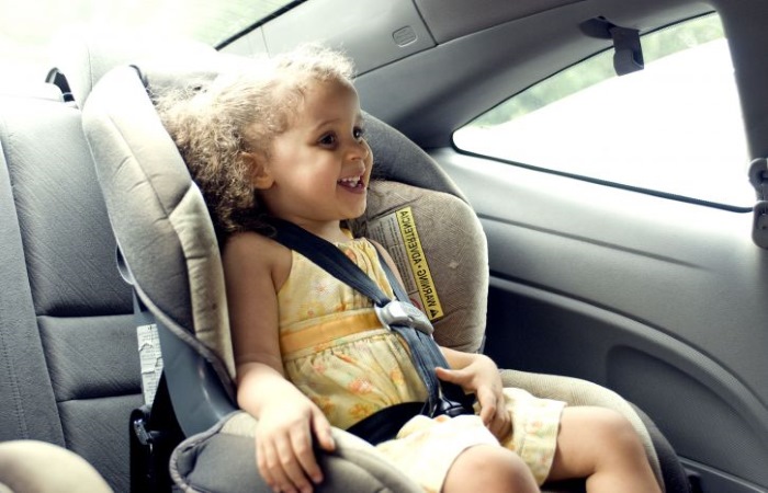 young girl in child car seat
